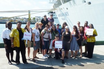 Sweet travelers posing beside a ship